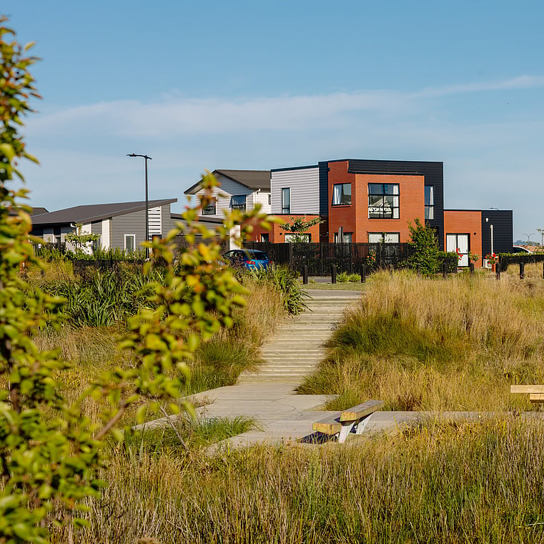 A photo of double story house while standing in middle of walkway 