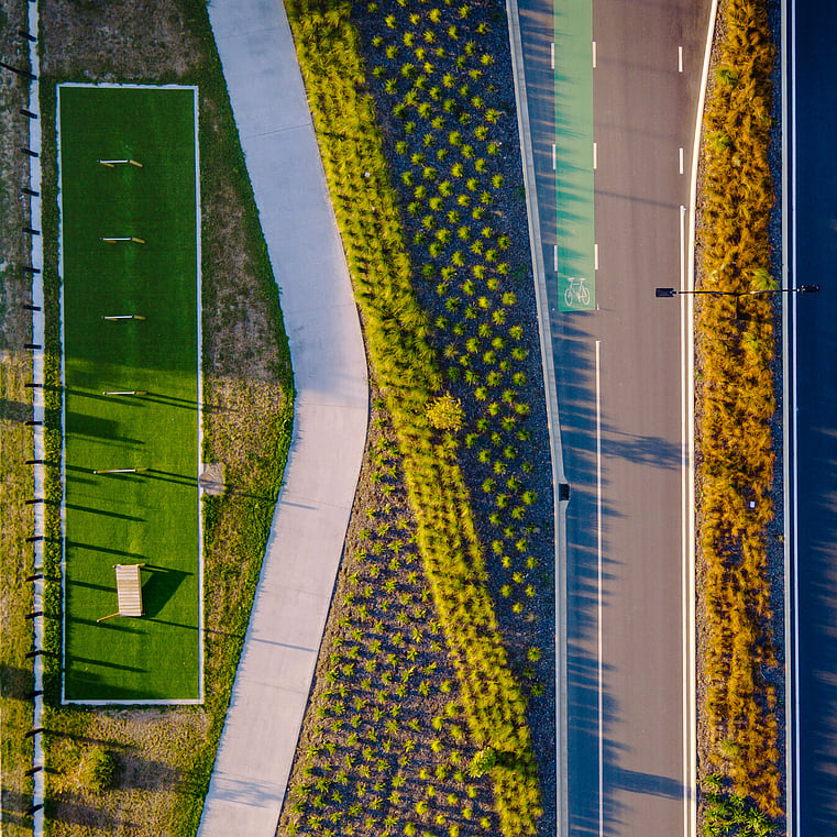 Eagle shot from drone of road and plants with a design