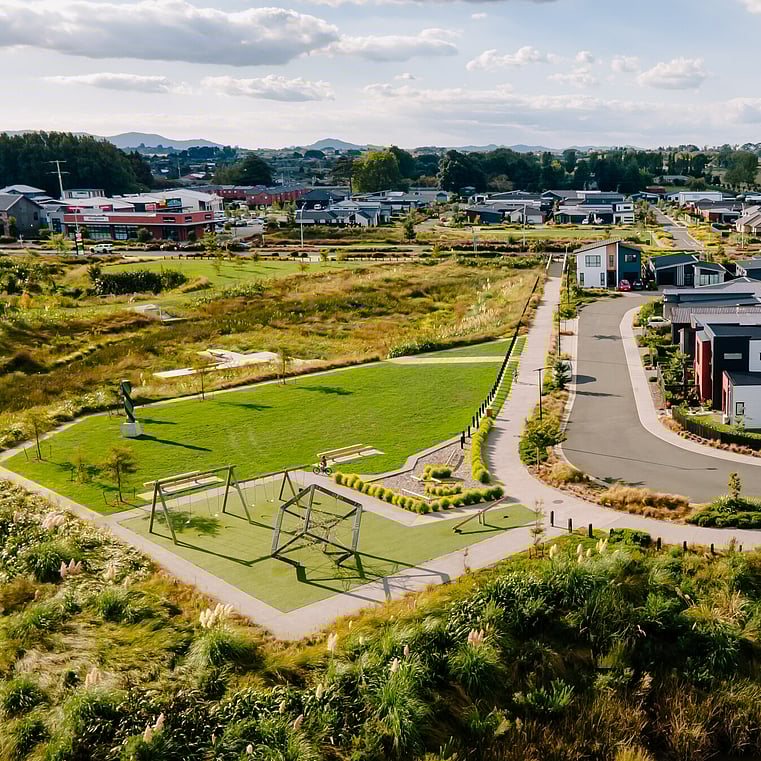 Drone shot of park with street and homes