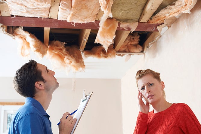 two people discussing a badly leaking roof