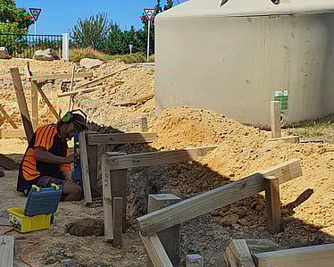 Building timber retaining wall foundation during excavation in Nelson