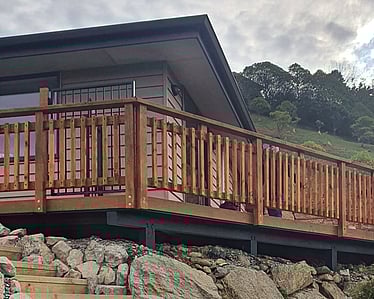 Timber balcony fence with retaining wall and stone steps in Nelson home