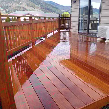 Polished timber deck with matching fence and rural views in Tasman