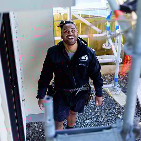 Kenco Construction builder looking up at scaffold on site