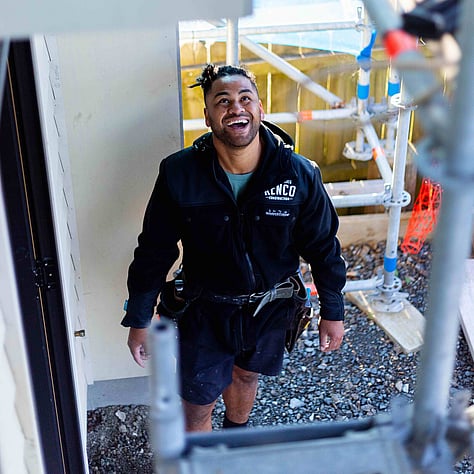 Kenco Construction builder looking up at scaffold on site