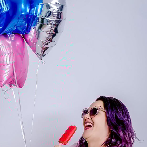 Happy Woman holding ice block and balloon