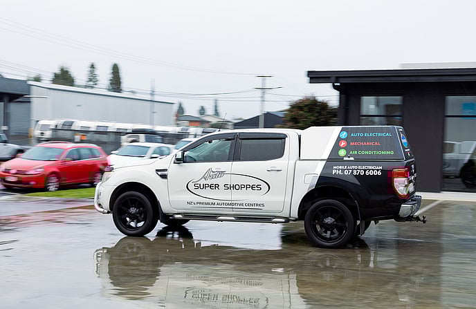 Truck and tractor sitting in a paddock