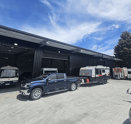 Cars, trailers & campervans parked outside the workshop