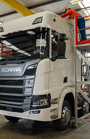 Man inspecting a heavy truck for truck preparation services