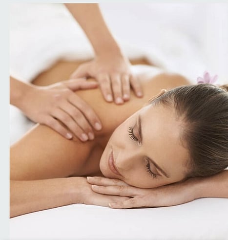 Picture of a lady lying on a massage bed having a back massage.