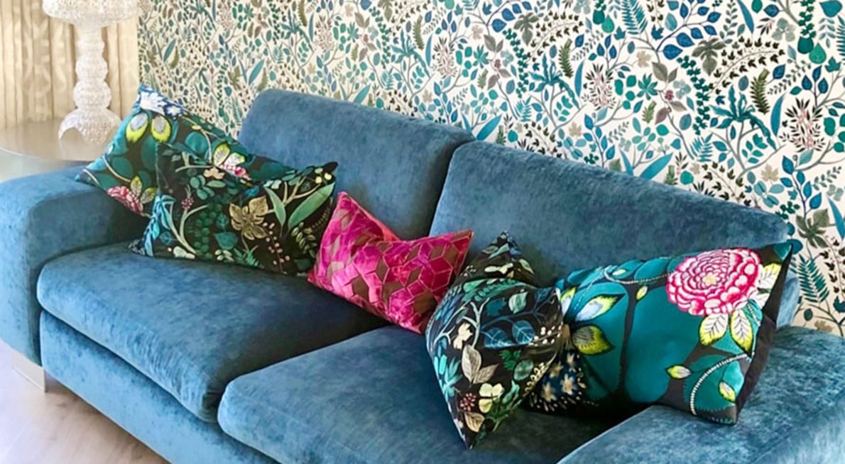 Blue couch with floral cushions and wallpaper. Upholstery and interior design and styling by Julia Empson Interiors. Ohaupo. Waikato, New Zealand.
