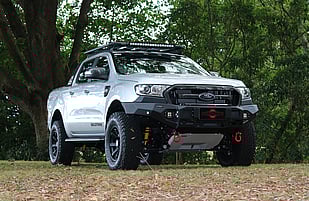 Featuring a Drivetech4x4 Rival Aluminium Bull Bar with LED Fog Lights, ARB D-Shackles, ARB Under Vehicle Protection Plate, ARB Powdercoated Summit Steps, Drivetech4x4 30" Lightbar, OME Suspension Lift, RhinoRack Platform Tray