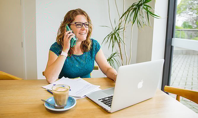 Wedding brand designer working at desk illustrating personal brand photography for wedding professionals