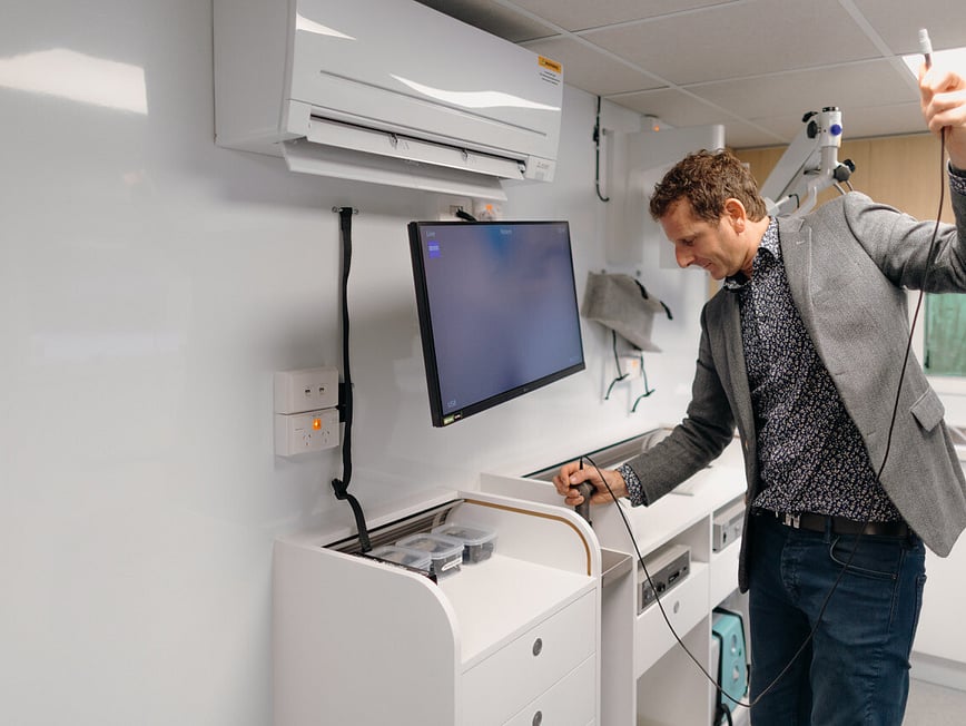 Dr David Waterhouse Leaning on the Tarapunga Mobile ENT clinic Van