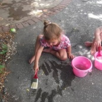 Sprouts Girl experiments with paint brush 