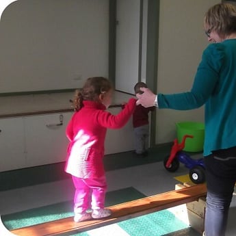 Sprouts educator helps child to balance