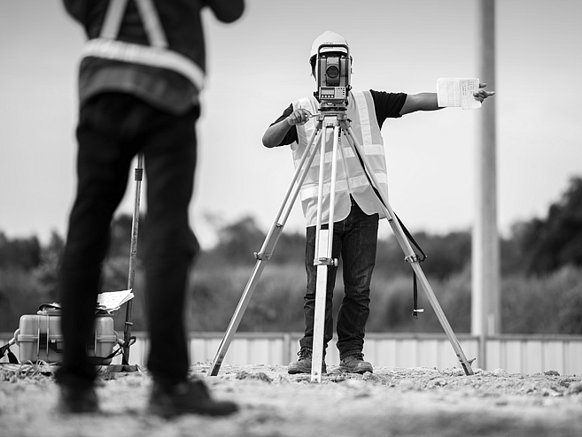 Man using surveying equipment