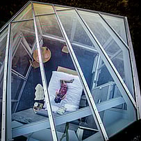 Aerial view of a SkyScape glass-roof bedroom beneath open skies