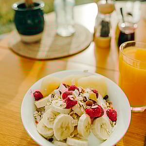 Continental breakfast with yoghurt, fruit, and juice at SkyScape