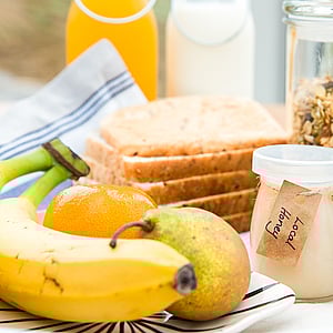 Continental breakfast with yoghurt, fruit, and juice at SkyScape