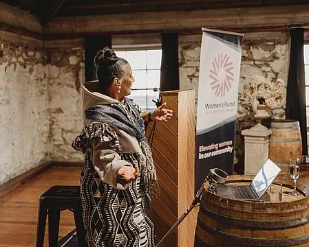 Anah Aikman hosting an impactful event as an MC, weaving storytelling and cultural traditions into an empowering experience for attendees.