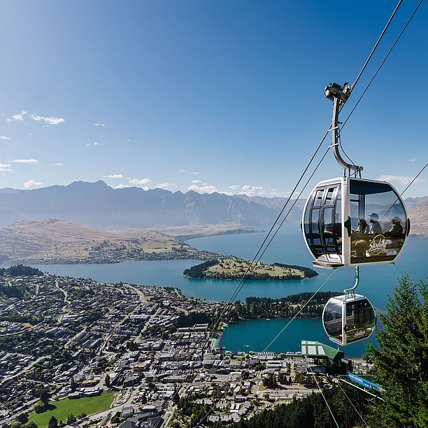 Gondola ride ascending Queenstown with lake and mountains view