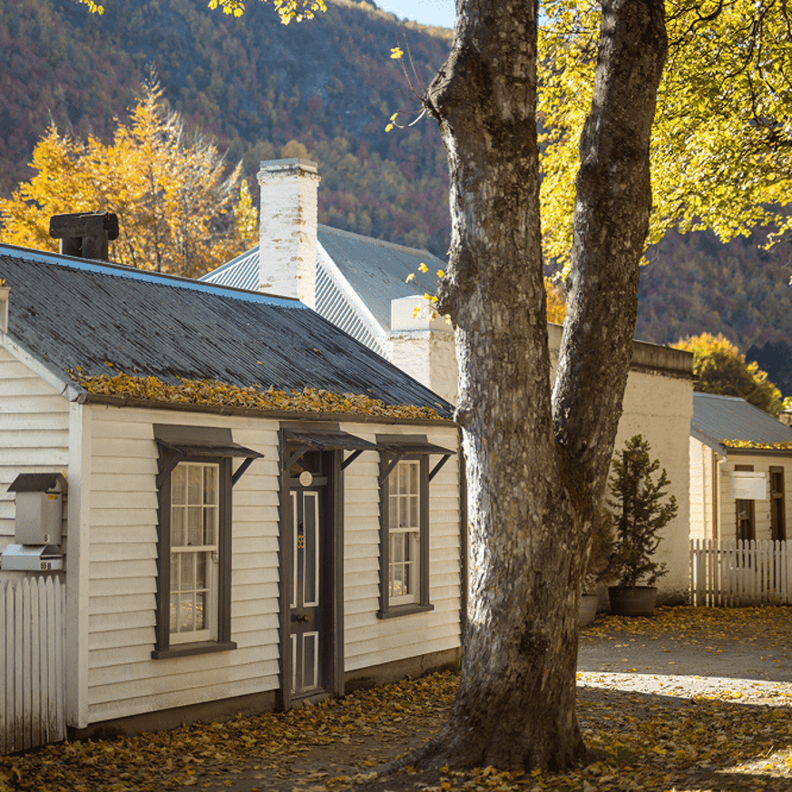 House in Arrowtown surrounded by autumn foliage