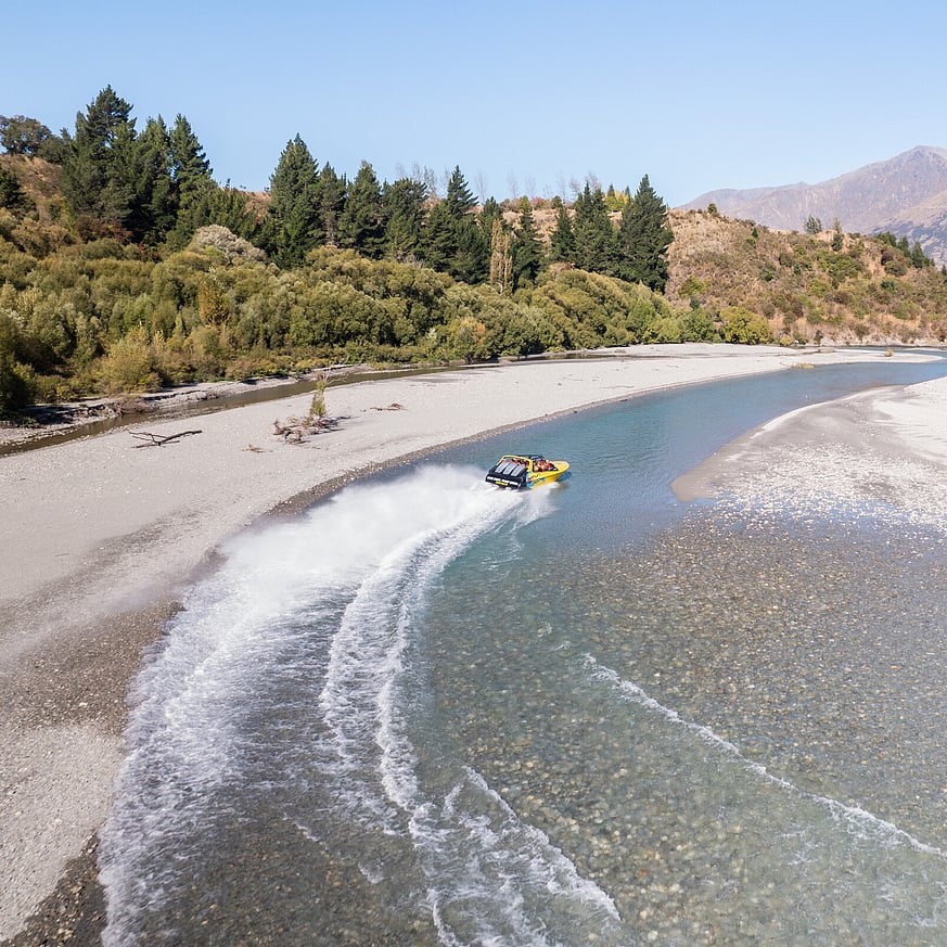 Jet boat speeding on water in Queenstown