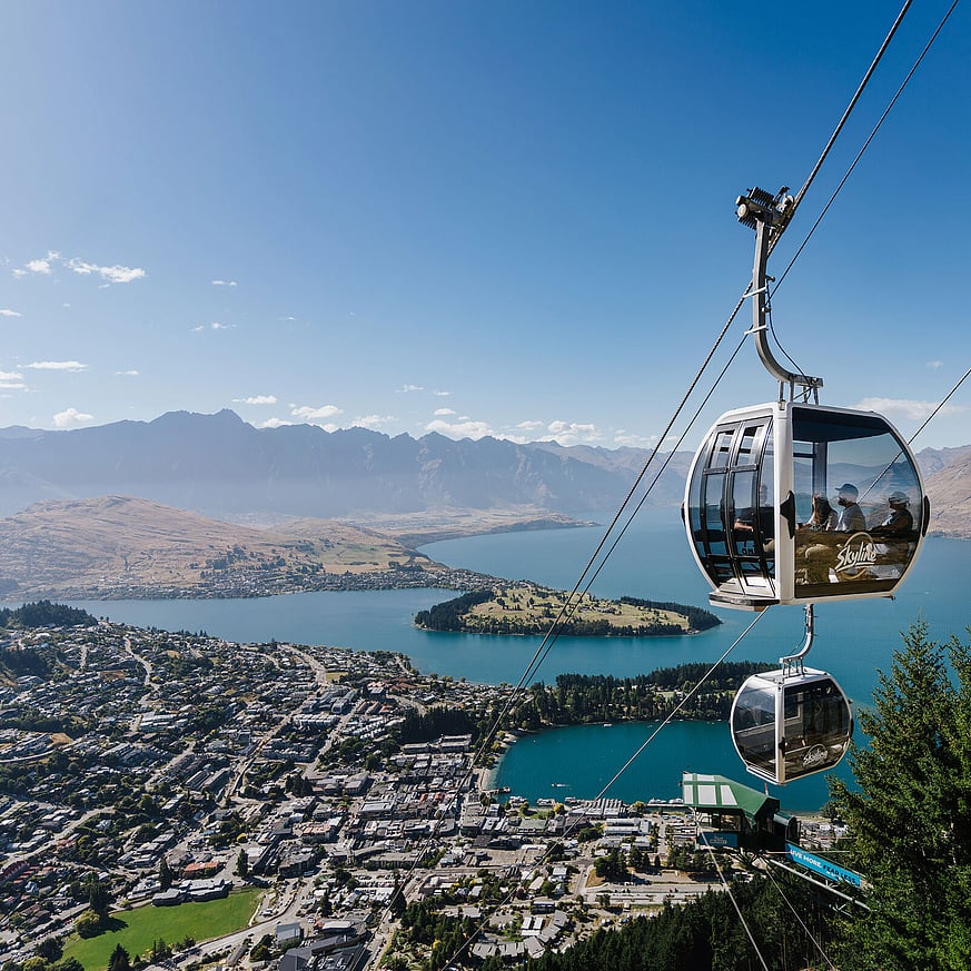 Gondola ride ascending Queenstown with lake and mountains view
