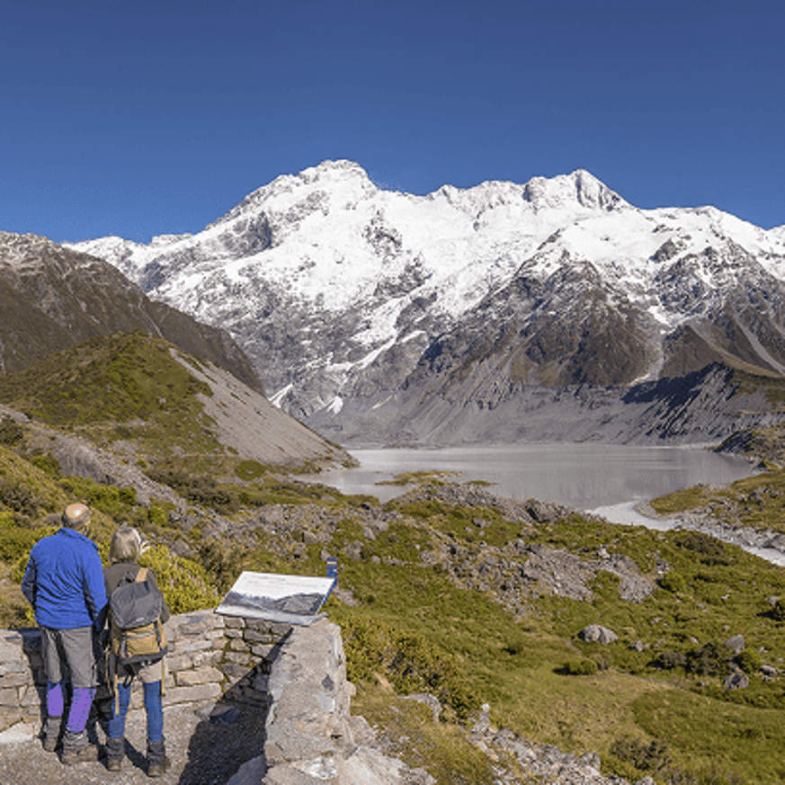 Couple looking at the snow-covered Southern Alps