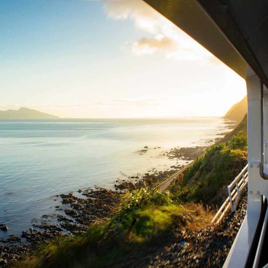 Coastal view from a train window overlooking the ocean