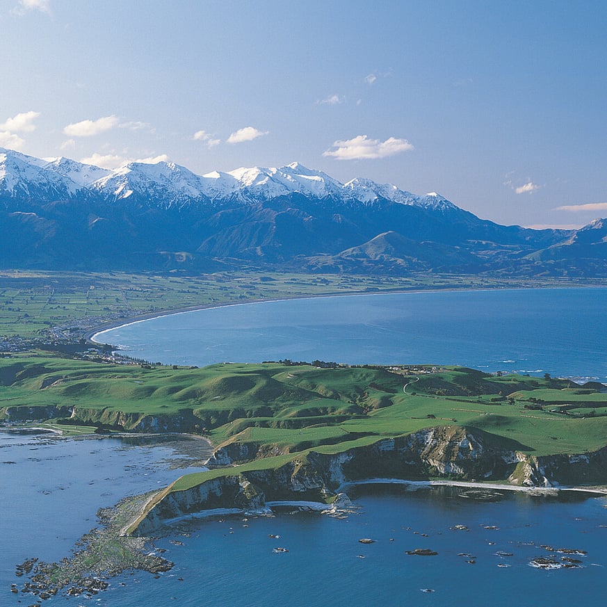 Drone view of Kaikōura coastline with the Southern Alps in the background