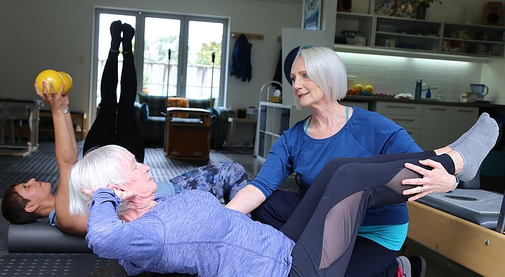 People working out at Turning Tide Pilates reformer studio