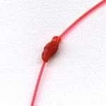 Knot will slide up and down under firm pressure.