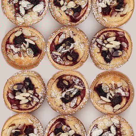 This is a photo of tarts they are called apple blackcurrant and frangipane tarts they are both gluten-free and dairy free
