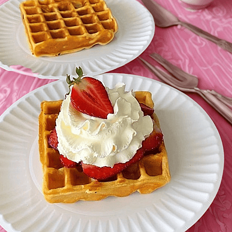 Gluten-free doughnuts with chocolate icing white icing and pink icing with decorative sprinkles in pink white blue orange yellow and green and hundreds and thousands