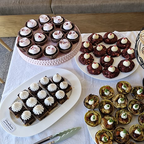 Delicious looking clear with some nuts sprinkled on top and chocolate icing dripping over the sides