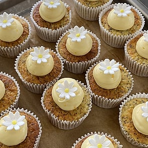 Photo of beautiful gluten free cupcakes with pale pink icing and white sprinkles