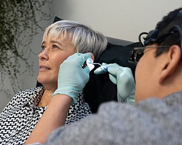 woman having ear wax removed at Wolfe hearing