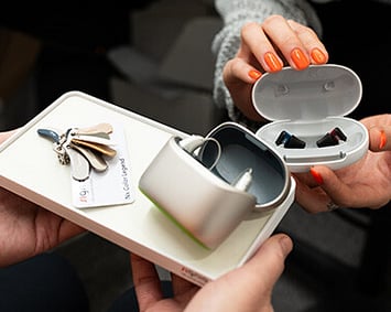 customer being shown a range of hearing aid styles and colours at Wolfe hearing