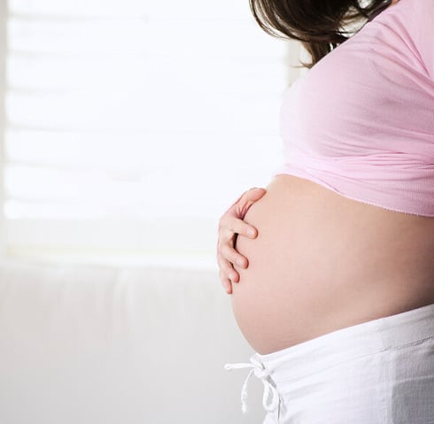 Picture of a pregnant women holding her belly