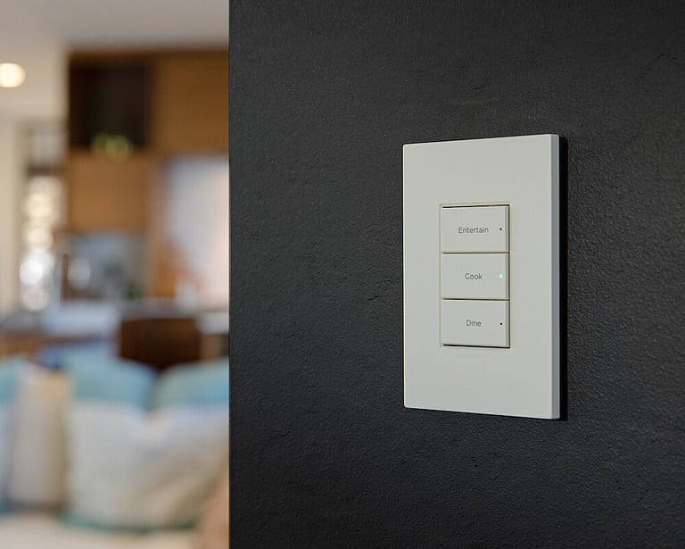 A wall switch with Automated selection options for lighting and shade control.