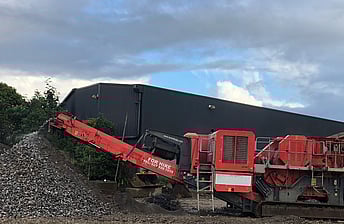 A Terex Finlay Jaw crusher machine outputting crushed waste concrete aggregate into a stockpile