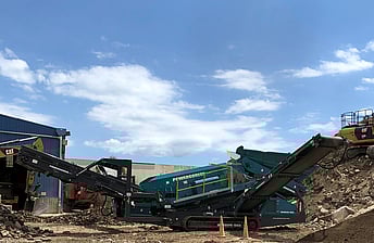 Powerscreen Warrior 1800 heavy duty screen showing 2-way split for outputting processed waste concrete