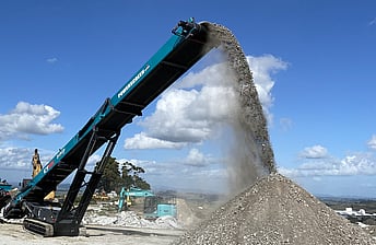 Powerscreen CT65 65foot tracked conveyor stockpiling into a large pile of crushed rock