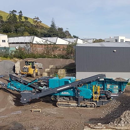 A Powerscreen Trakpactor 260SR impact rock crusher working on crushing waste concrete