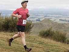 Trail runner, all smiles at blazing hills, on top of a hill with all the views