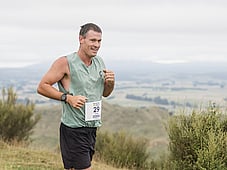 Trail runner, all smiles at blazing hills, on top of a hill with all the views