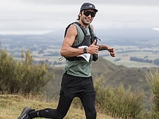 Trail runner, all smiles at blazing hills, on top of a hill with all the views . Sunglasses and happiness while running