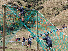 OCR Blazing Hills, Cargo net, A frame, high in the air people climbing over. Obstacle